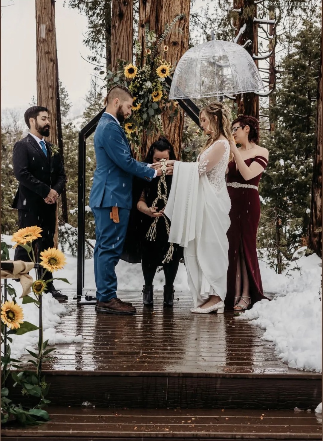 Officiant performing a winter ceremony surrounded by sunflowers and light snow